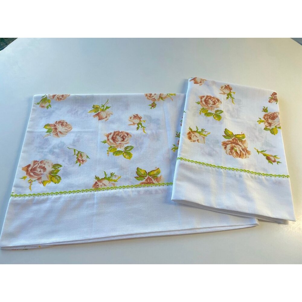 Pair of vintage 70s pillowcases, orange green floral, white background